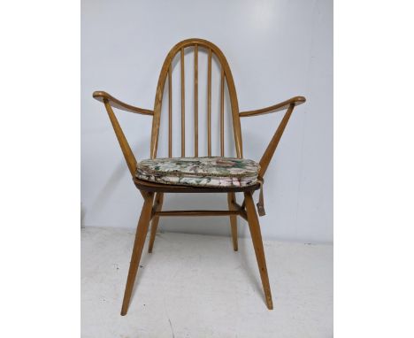 An Ercol Quaker dining chair with loose upholstered seat and late mid-century Ercol dark wood armchair with loose upholstered