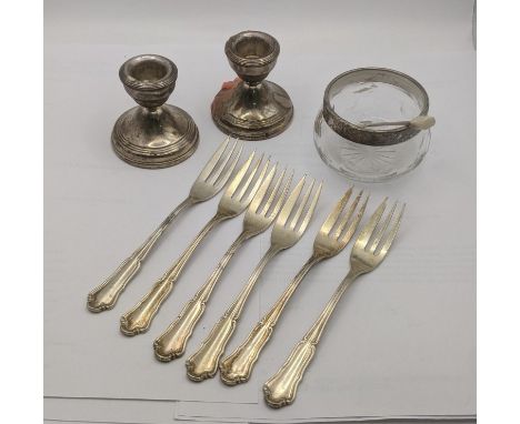 A mixed lot of silver to include a pair of dwarf candle stick holders having weightless bases, a silver rimmed glass dish and