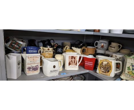 A large collection of whisky jugs to include The Real Mackenzie, McNish, Isle of Jura Pure Malt Scotch Whisky and other examp