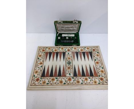 A Backgammon set with cased pieces with a quartz board, marquetry inlay sitting a wooden tableLocation:If there is no conditi