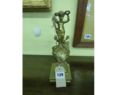 FRENCH GILT METAL MYSTERY CLOCK ADORNED WITH CHERUB AND TROPHIES WITH KEYS 24CM HIGH APPROX 