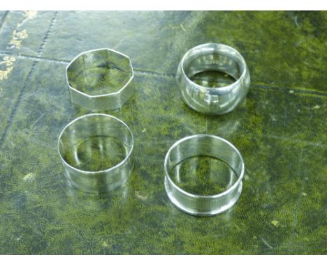 THREE HM SILVER NAPKIN RINGS AND A WALKER AND HALL PLATED NAPKIN RING 