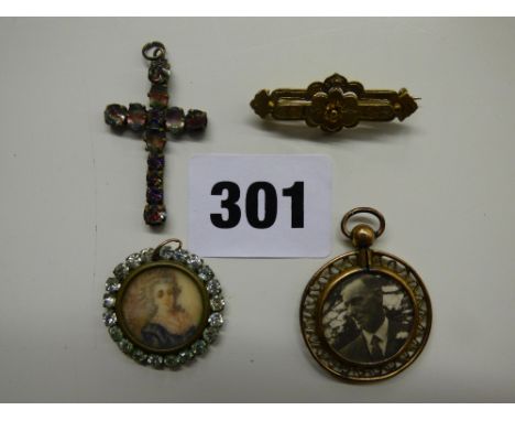 TWO UNMARKED YELLOW METAL CIRCULAR PORTRAIT PENDANTS, A PASTE CRUCIFIX PENDANT WITH MOTTLED DETAIL AND A VICTORIAN YELLOW MET