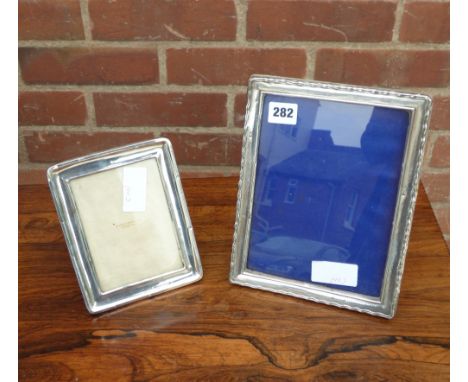 HM BIRMINGHAM SILVER SERPENTINE EDGED PHOTO FRAME AND A MAPPIN & WEBB SILVER PHOTO FRAME - BOTH WITH EASEL BACK 