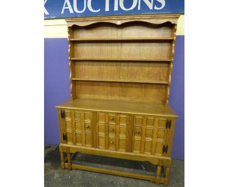 20TH CENTURY LIGHT OAK GUILD SCHOOL INSPIRED DRESSER WITH PANELED DOOR FRONTS AND ROUND WOODEN HANDLES STANDING ON A SIX LEGG