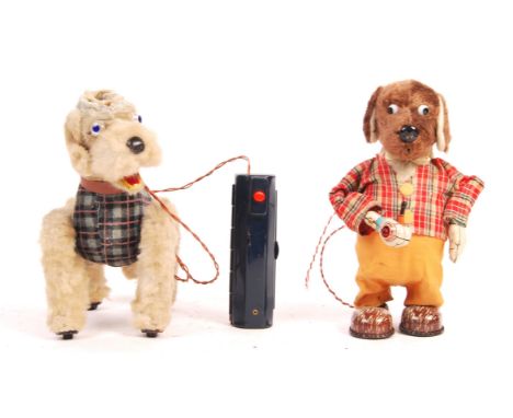 Two original vintage 1950's battery operated Japanese tinplate and plush toys comprising a Poodle dog in tartan outfit with b