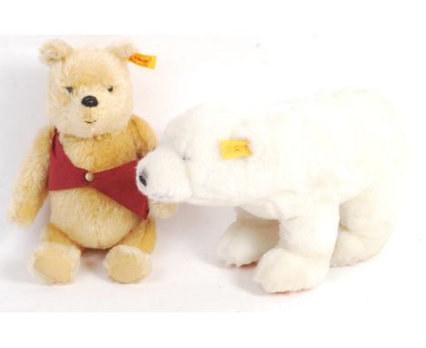 Two original German Steiff made teddy bear stuffed toy animals comprising a 660474 Winnie The Pooh with gold button to ear an