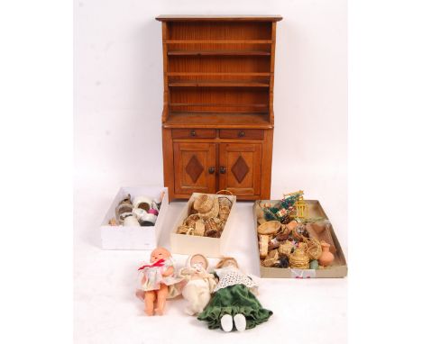 A collection of assorted antique and vintage dolls house furniture and other items to include; wooden dresser, antique bisque