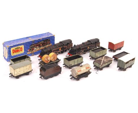 A collection of original vintage Hornby Dublo 00 gauge model railway train set locomotives and rolling stock comprising a box