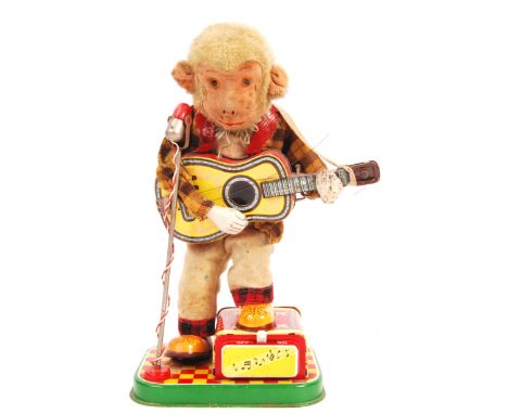 A rare original vintage 1950's Alps made in Japan Japanese battery operated tinplate and plush ' Rock &amp; Roll Monkey. The 