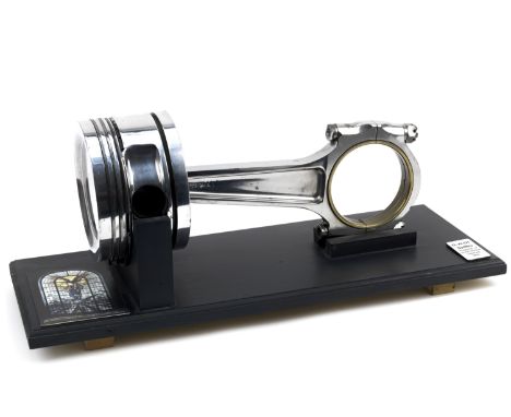 A Rolls-Royce aero engine piston and connecting rod,highly polished, 39cm long, on wooden display base, 53 x 20.5cm overall. 