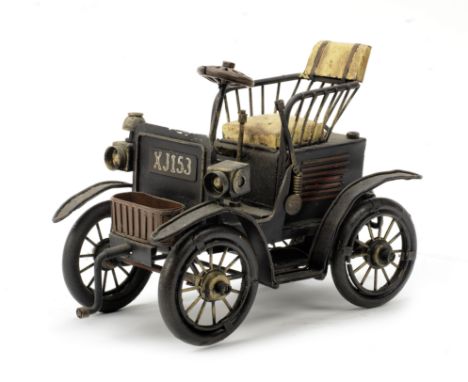 A scratch-built model of an early steam car,modern, tin-plate model of a single-seater, rustic construction deliberately aged