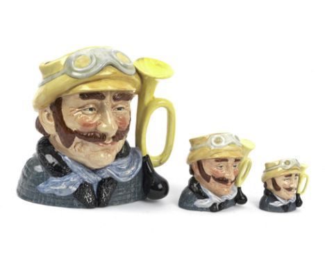 A set of Royal Doulton 'Veteran Motorist' jugs, 1972,each glazed ceramic, three graduated sizes in small 7cm high, medium 10c