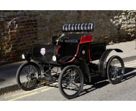 A superb 1:2 scale model of a 1901 Curved Dash Oldsmobile child's car,painted black with red details and gold coach-lining, b