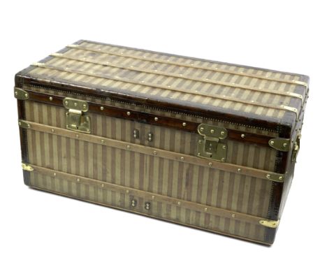A Louis Vuitton 'Courier' trunk, 1885-1890,striped beige and brown 'rayee' canvas exterior, with brass handles, locks and cat