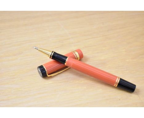 A Parker Centennial Special Edition rollerball pen in orange with one broad and one narrow cap band.