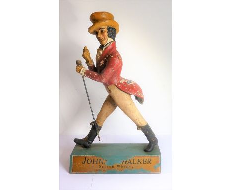 An original Johnnie Walker Scotch Whisky plaster advertising model upon a wooden plinth base