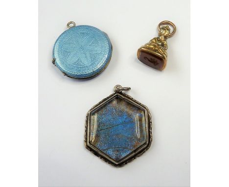 A circular white-metal and blue-enamel photo locket together with an hexagonal white-metal and stone-mounted pendant of simil