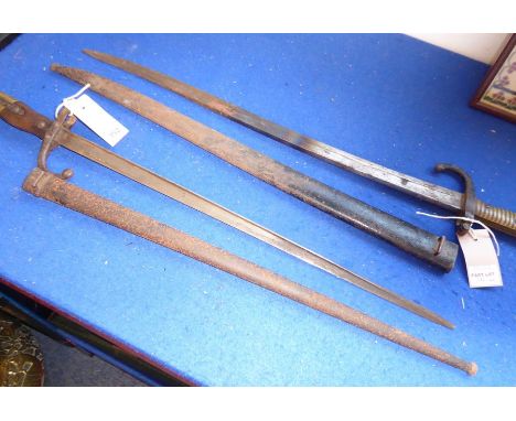 A 19th century French bayonet within metal scabbard; dated 1872 and with ribbed brass handle, together with one other similar