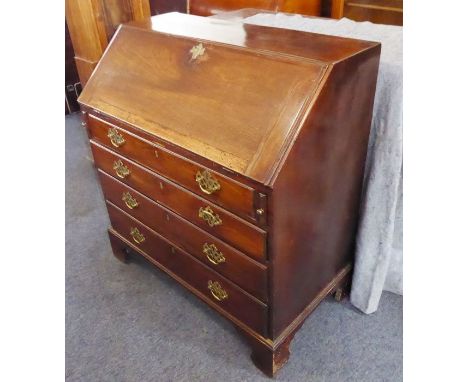 A late 18th century mahogany writing bureau; the angular cleated fall opening to reveal fitted interior with a central cupboa