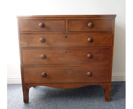 An early 19th century cherrywood and pine-sided chest of small proportions; two half-width over three full-width graduated dr