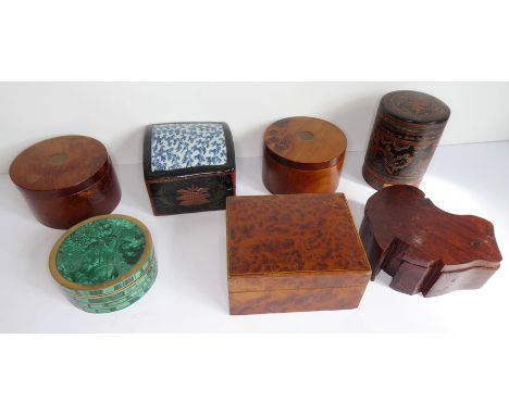 A good selection of mostly treen boxes; to include a circular malachite and copper-mounted example, a lacquered Chinese box w