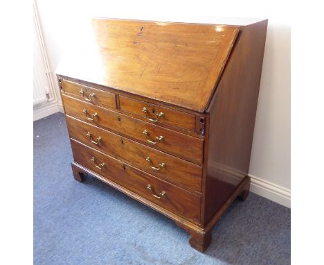 A late 18th century mahogany writing bureau; the angular-cleated fall opening to reveal fitted interior of six arched pigeon-