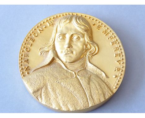 A heavy gilt-bronze medallion depicting Napoleon I in relief (9.5cm diameter)(The cost of UK postage via Royal Mail Special D