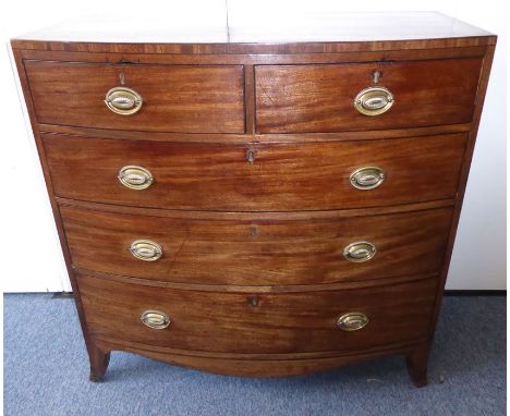 An early 19th century bow-fronted mahogany chest; caddy top,&nbsp;two half-width over three full-width graduated drawers, sha