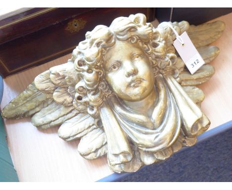 A 19th century ormolu bracket with a cherub's face surrounded by feather design, in original condition (48cm wide x 20cm x 18
