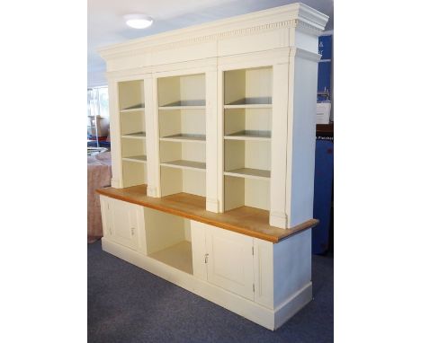 A large cream and green-painted natural oak display case; dentil cornice above shelf space and two panelled covered doors bel