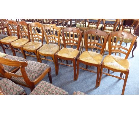 Seven early 20th century French 'moustache' ladder-back chairs;&nbsp;rush seats and square cabriole front legs