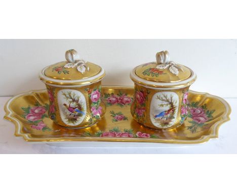 A 19th century porcelain double inkwell on stand; decorated with pink roses against a gilded background, the inkwells with li