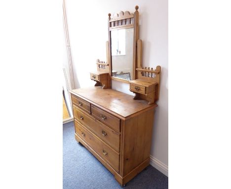 An early 20th century pine mirror-topped dressing chest; two half-width over two full-width drawers raised on bracket feet wi