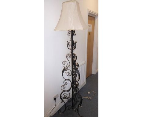 A wrought-iron lamp standard and shade on tripod base