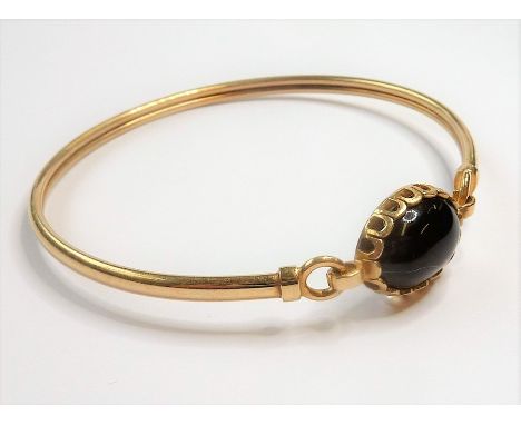 A 9-carat gold stone-set bangle (5.6g)&nbsp;(The cost of&nbsp;UK postage&nbsp;via Royal Mail Special Delivery for this lot wi