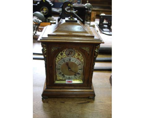A late 19th century oak and cast brass mounted mantel clock, striking on two gongs, 42cm high. 