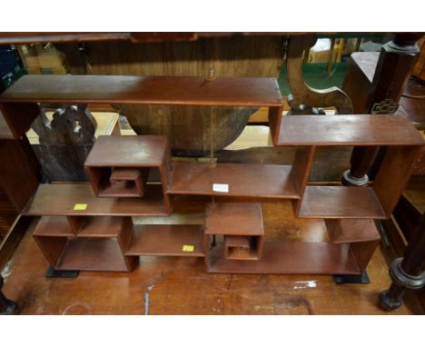 A Chinese hardwood assymetric hanging display shelf, 82cm wide..