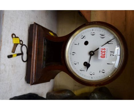 An old oak balloon mantel clock, with white enamel dial, 31.5cm high, with winding key.