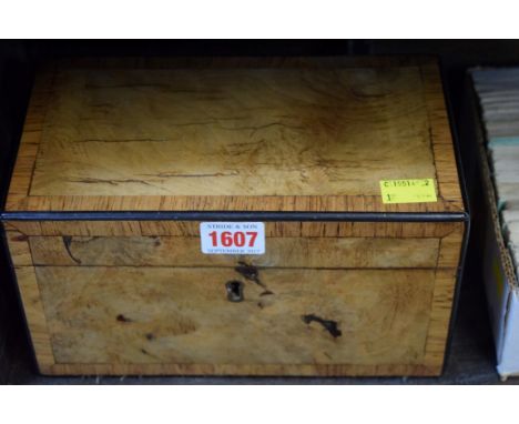 An early 19th century walnut and rosewood crossbanded tea caddy, 23cm wide. 