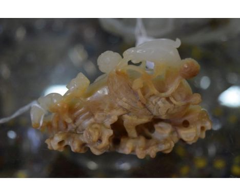A Chinese pale celadon and brown jade phoenix, 9cm wide. 
