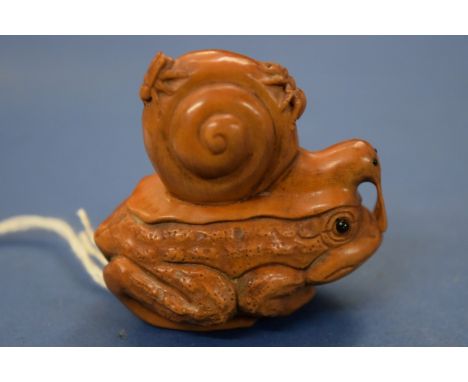 A Japanese carved wood netsuke figure group, of a toad, snail, spider and fly, 5cm high. 