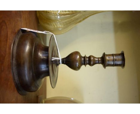 An 18th century Nuremberg patinated brass candlestick, 17.5cm high. 
