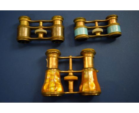 Three pairs of opera glasses, to include a blue guilloche enamel and gilt metal example.