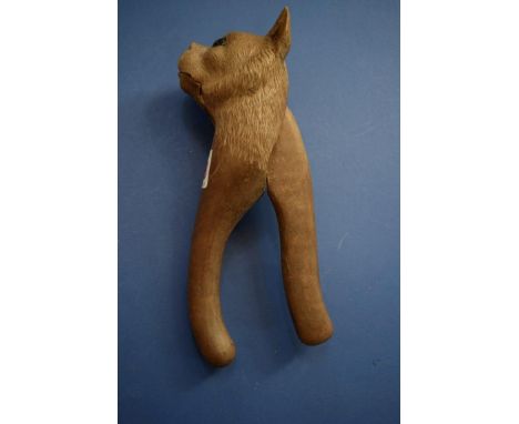 A Black Forest carved wood cat nutcracker, with glass eyes, 19cm long. 