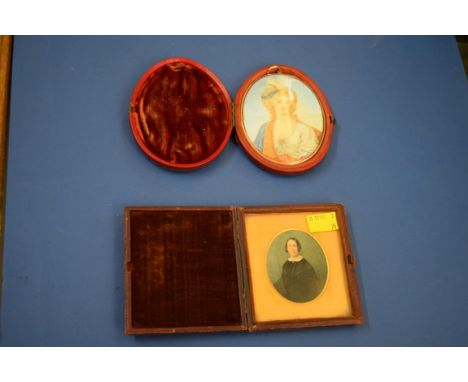 A bust-length portrait miniature of a lady, probably on ivory, 9.5 x 7.5cm oval, in leather case; together with another minia