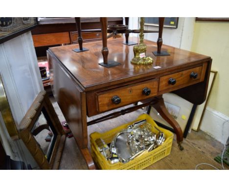 An unusual early 19th century mahogany and crossbanded drop leaf library or sofa table, with two pairs of opposing frieze dra