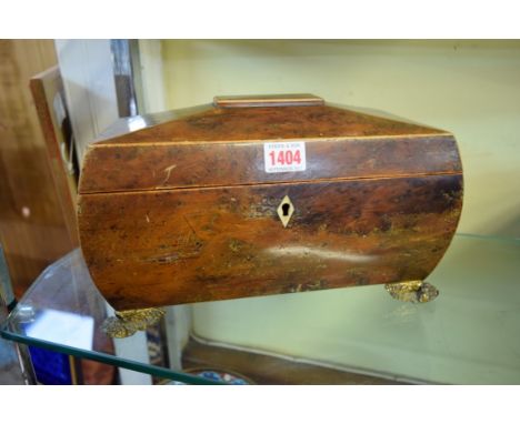 A Regency yew wood sarcophagus form tea caddy, on brass paw feet, 30.5cm wide. 