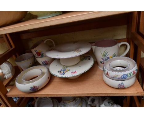 A collection of nine items of Poole pottery. 