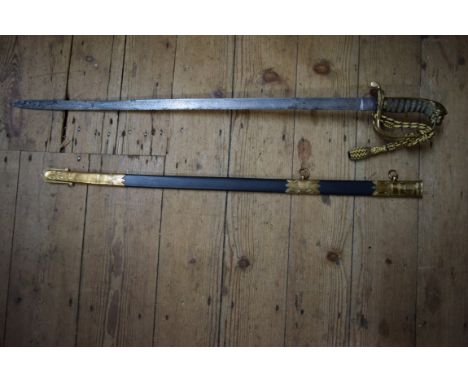 A Victorian naval officer's dress sword and scabbard, the scabbard bearing plaque 'Whiteman, Outfitter, Woolwich'.